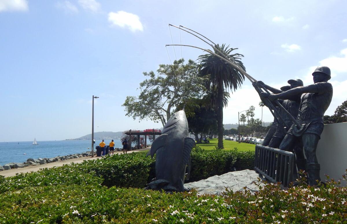 Sailors run past the Tunamen’s Memorial in Shelter Island Shoreline Park.