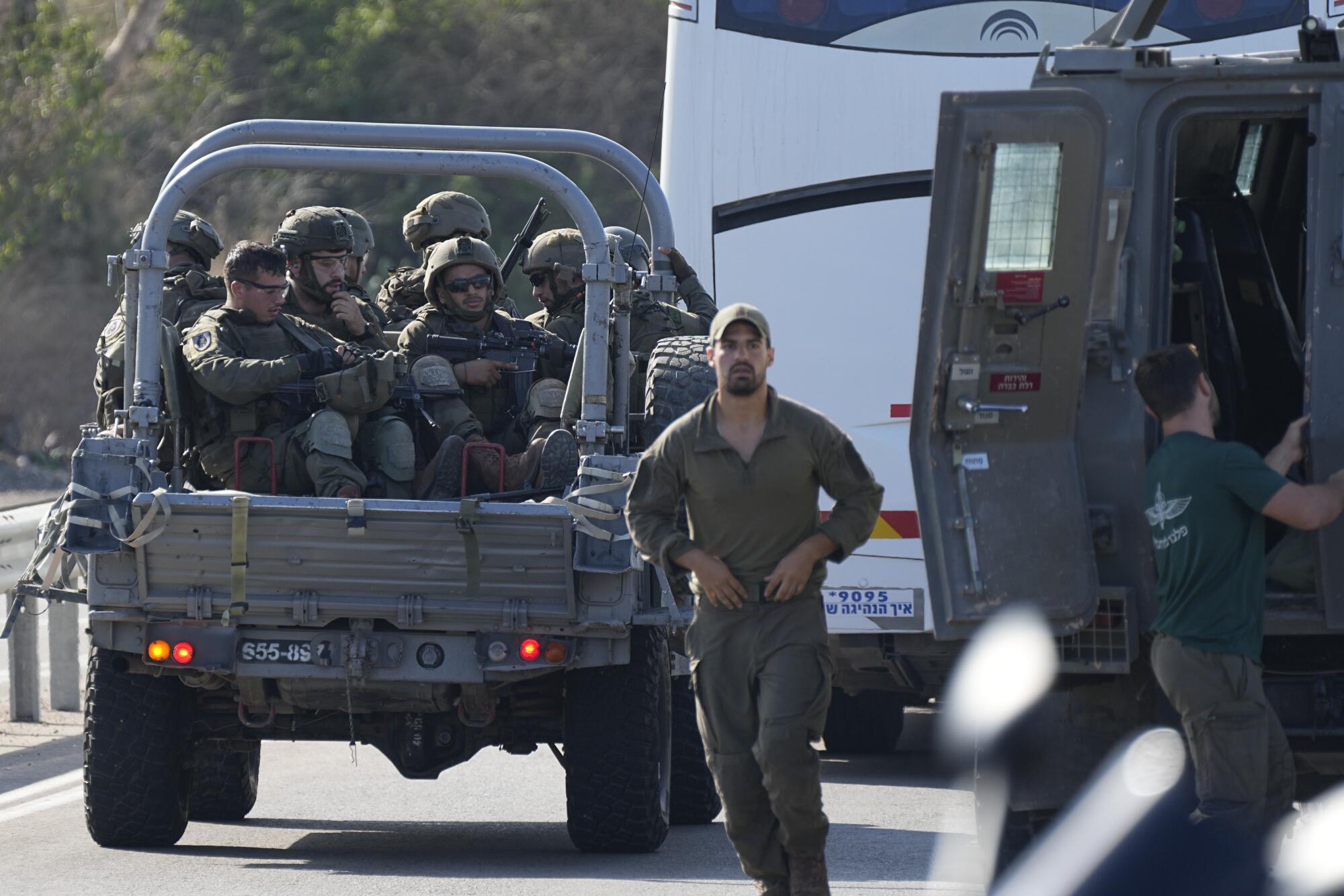 Israeli soldiers in a military vehicle headed to southern Israel