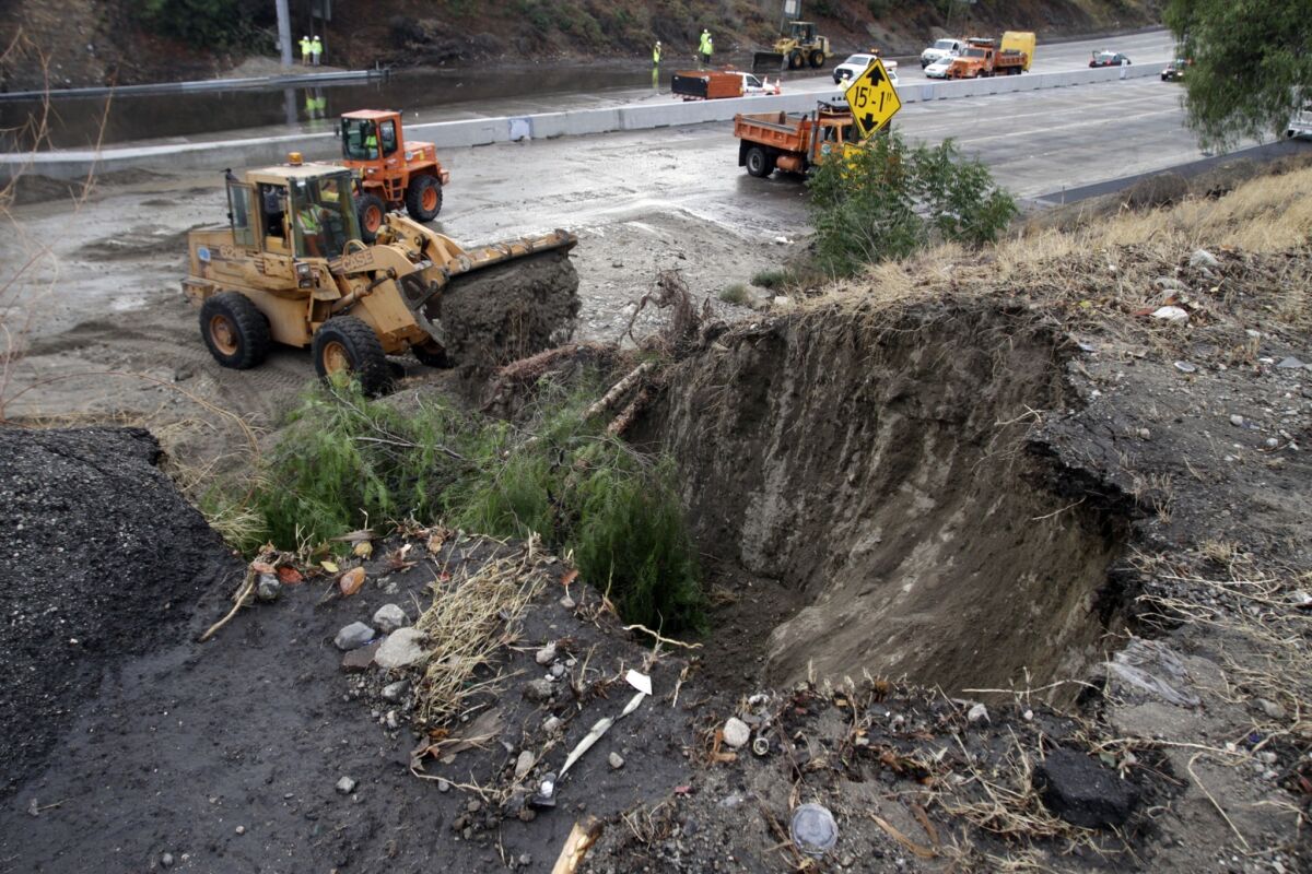 About 22% of the 6,295 freeway miles in Los Angeles and Ventura counties have major potholes, severe cracks or are otherwise in bad condition. Above, bulldozers clear a mudslide off the 5 Freeway.