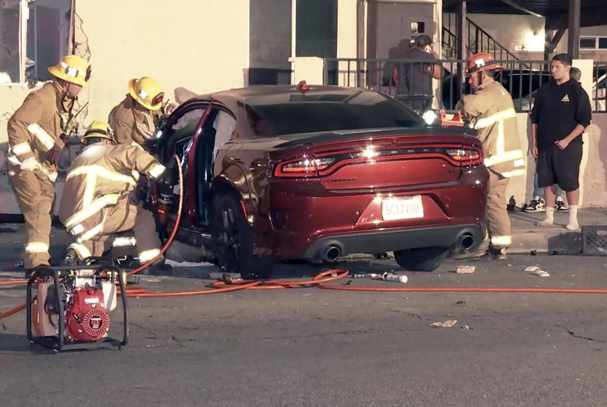 First responders work to extricate people from a car following a two-vehicle crash Sunday night in Pacoima