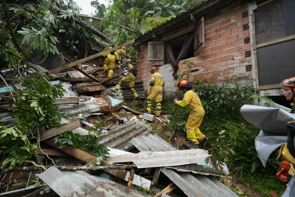 Rescue workers search in a ruined house