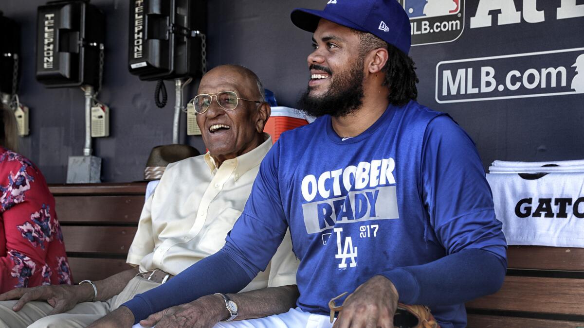 Dodgers pitching legend Don Newcombe chats with Kenley Jansen before Game 1 of the NLCS.