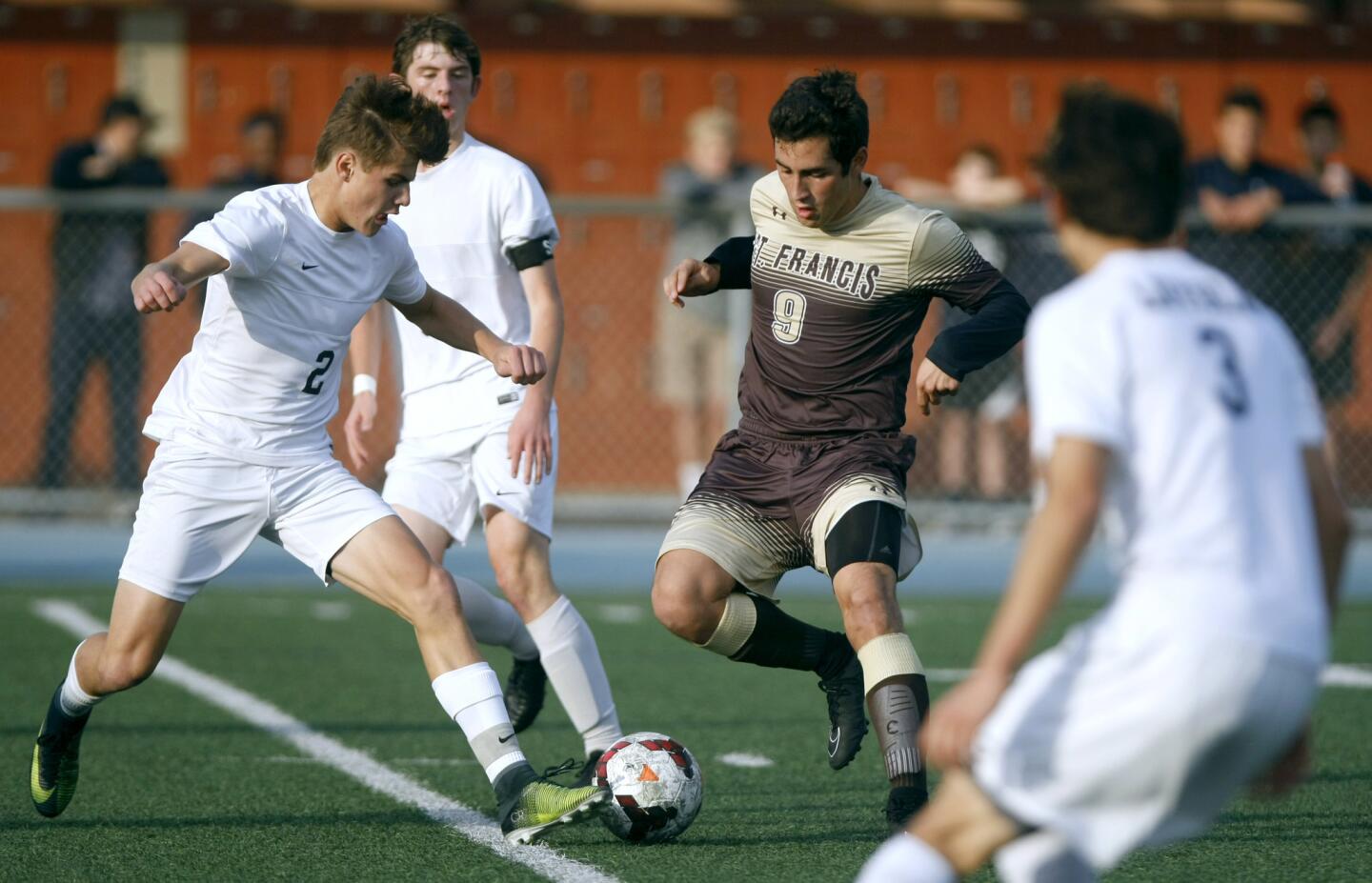 St. Francis High School soccer player #9 Colton Ramirez is overwhelemed by the defense in away game vs. Loyola High School at the Cub's field in Los Angeles on Friday, Jan. 13, 2017. The Golden Knights of St. Francis lost 0-2.