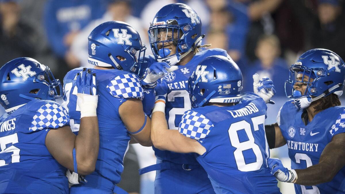 Kentucky running back Benny Snell Jr. (26) celebrates with teammates after scoring a touchdown during the second half against Mississippi State on Saturday.
