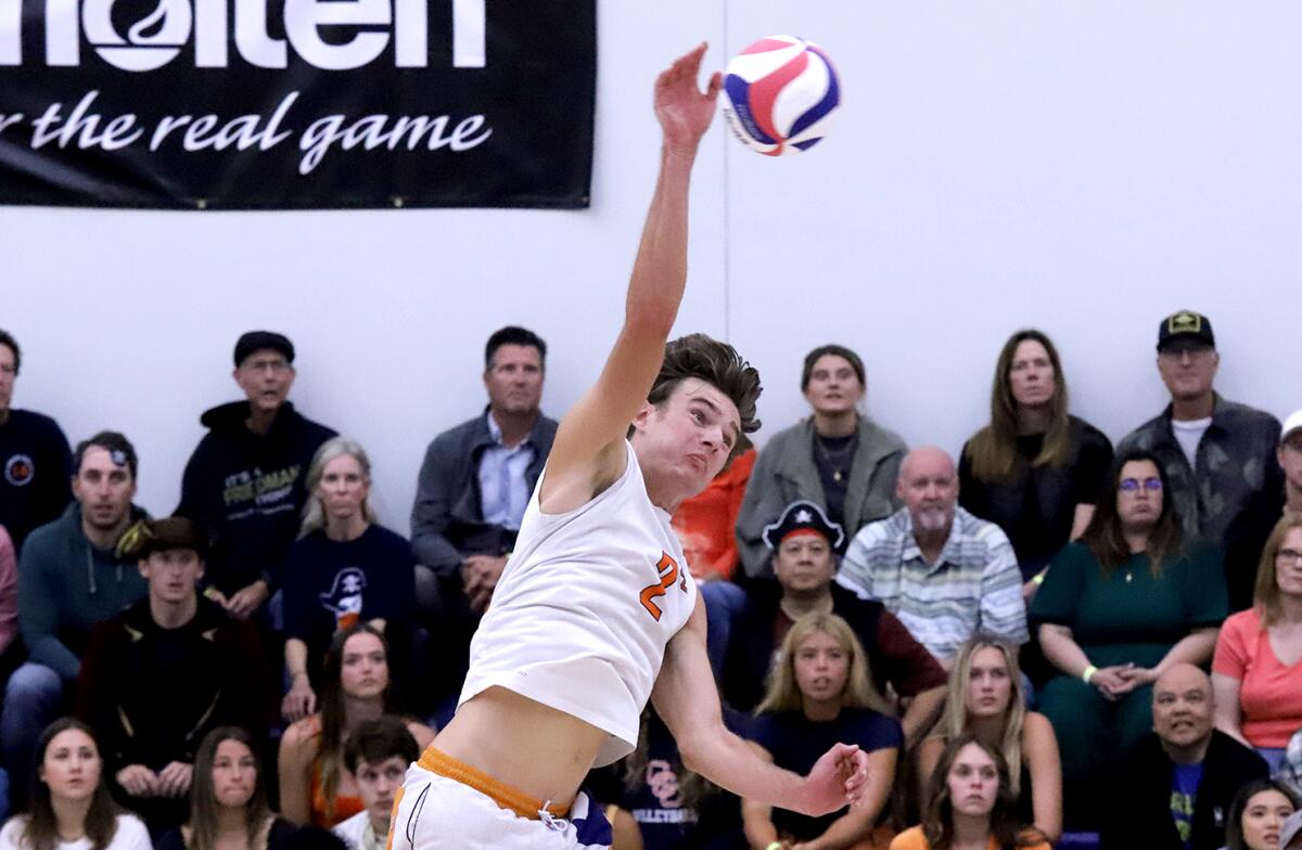 Orange Coast's Cash Adamsen (2) takes a swing against Long Beach in the CCCAA men's volleyball final on Saturday.