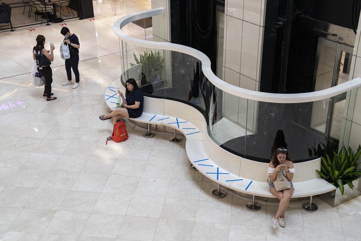 People observe safe distancing at a shopping mall in Singapore.