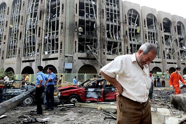 An Iraqi weeps as he walks away from the Justice Ministry after a bombing. Twin suicide attacks a block apart in the Iraqi capital killed about 150 people and injured about 700.