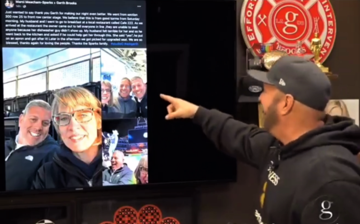Garth Brooks points to a photo of Heath and Marci Sparks in their original concert seats near the top row on Facebook Live.