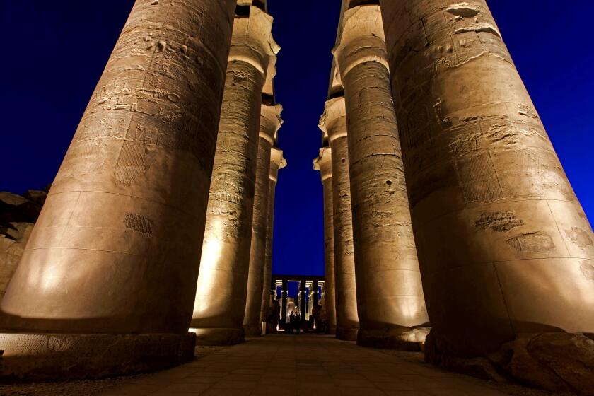 On this Wednesday, April, 30, 2014 photo, tourists visit Luxor Temple, a large ancient Egyptian temple complex on the east bank of the Nile River in Luxor, Egypt. Egyptian tourism officials, who Wednesday unveiled a replica of the tomb of King Tutankhamun in the desert valley where many of its ancient pharaohs were buried, are hoping the exhibit will help revive a tourism industry that has been heavily battered by the country's unrest since the 2011 uprising that toppled autocrat Hosni Mubarak. (AP Photo/Khalil Hamra)