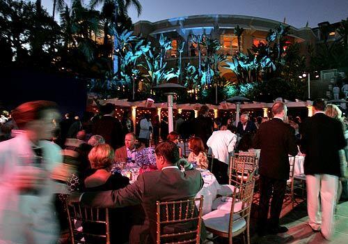 Guests take their seats for dinner at the Yves Saint Laurent "Pool Party" at the Beverly Hills Hotel to benefit Center Dance Arts.