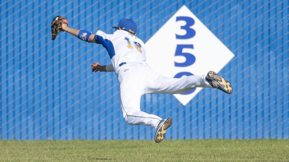 Fountain Valley High's Jake Bitzer makes a leaping catch in center field, robbing Huntington Beach's Jag Burden of an extra-base hit in the sixth inning on Friday.
