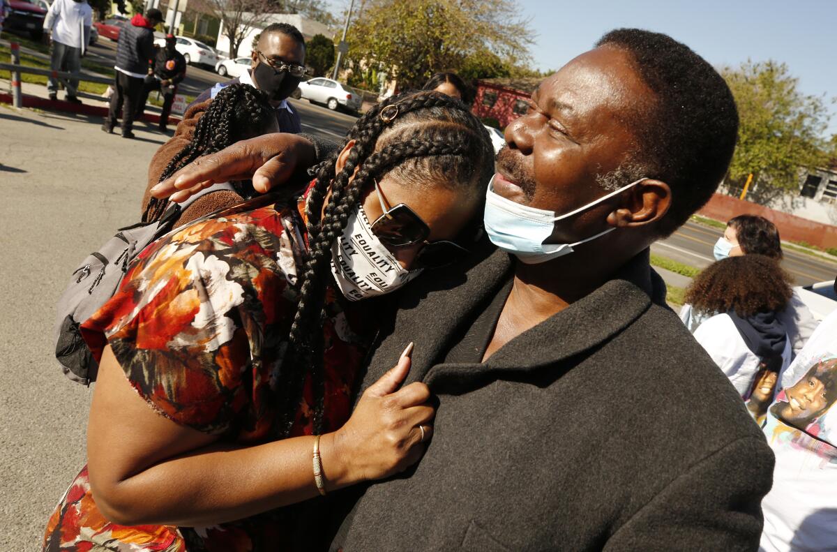 Shinese Harlins-Kilgore, cousin of Latasha Harlins, is hugged by her stepfather, David Bryant 