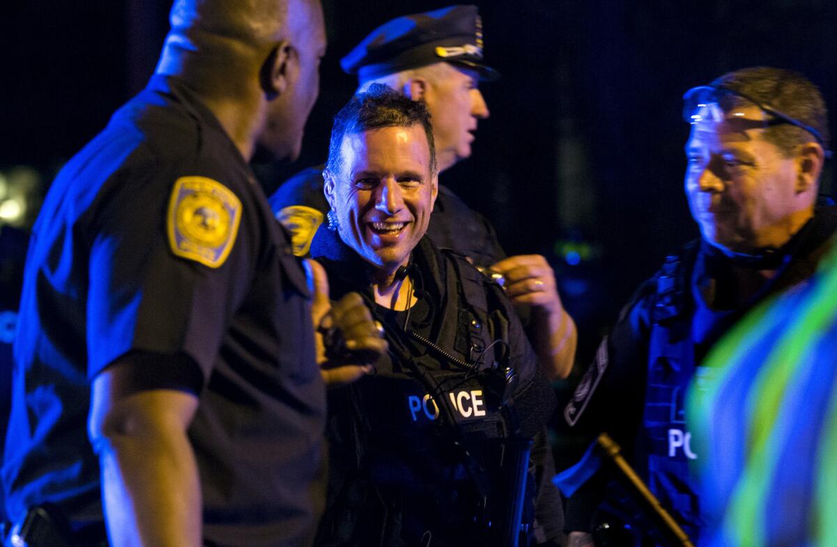A police officer gives a thumbs up in Watertown, Mass., after the second of two suspects in the Boston Marathon bombing was captured.