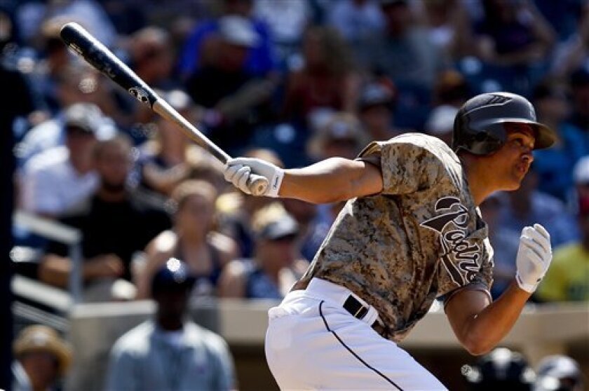 San Diego Padres' Will Venable watches his run-producing single against the Colorado Rockies during the seventh inning of the Padres' 3-2 victory in a baseball game on Sunday, July 22, 2012, in San Diego. 
