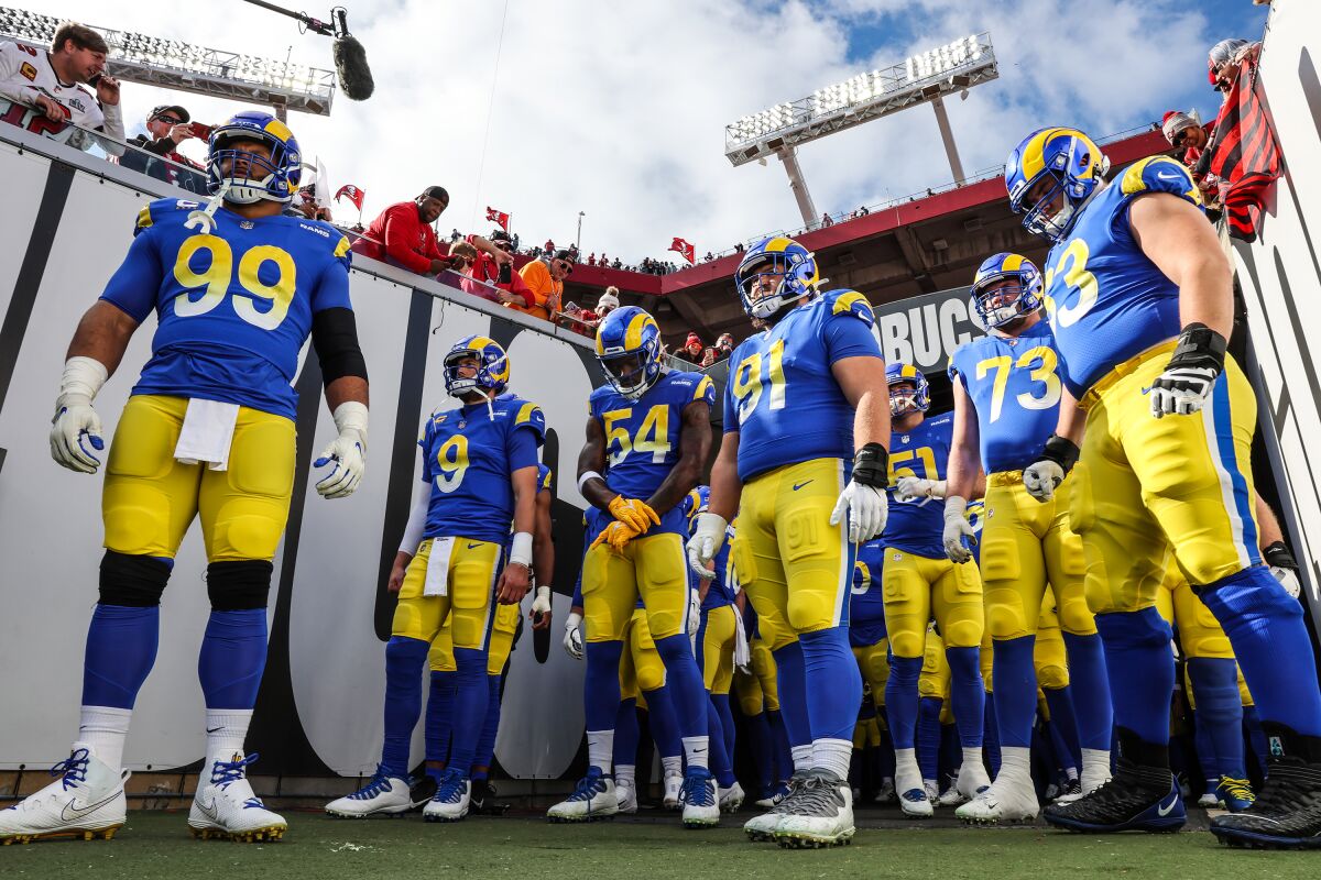 Rams defensive lineman Aaron Donald (99) leads teammates to the field in Tampa.