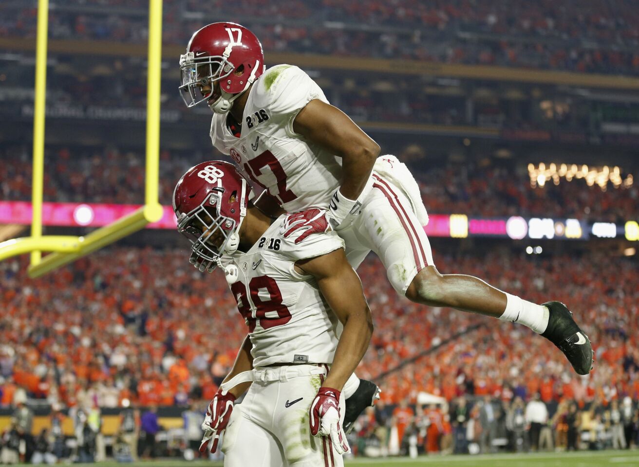 Alabama running back Kenyan Drake (17) celebrates with tight end O.J. Howard after Howard's second touchdown catch.