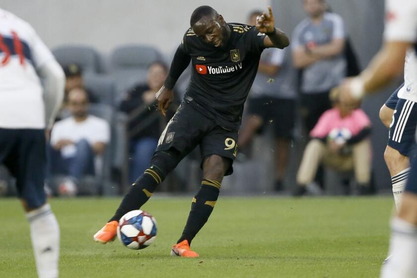 Los Angeles FC forward Adama Diomand takes a shot against the Vancouver Whitecaps during the first half of a Major League Soccer game in Los Angeles, Saturday, July 6, 2019. (AP Photo/Alex Gallardo)