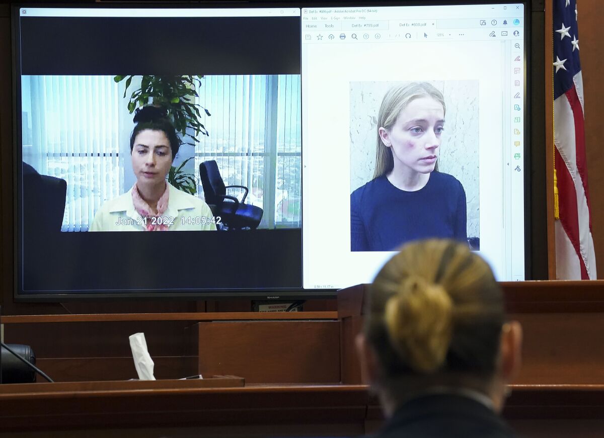 A woman is seen testifying via recorded video about a photo of another woman
