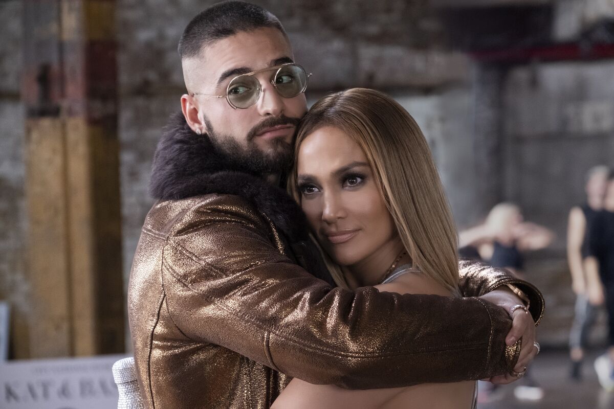 This image released by Universal Pictures shows Jennifer Lopez, right, and Maluma in a scene from "Marry Me." (Barry Wetcher/Universal Pictures via AP)