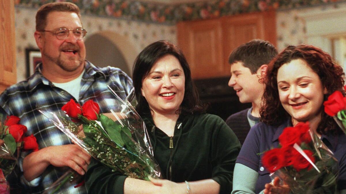 Roseanne Barr, center, basks in applause with costars John Goodman, left, and Sara Gilbert after taping was completed on the 221st and final episode of the first incarnation of the show, April 4, 1997, at Radford Studios in Los Angeles.