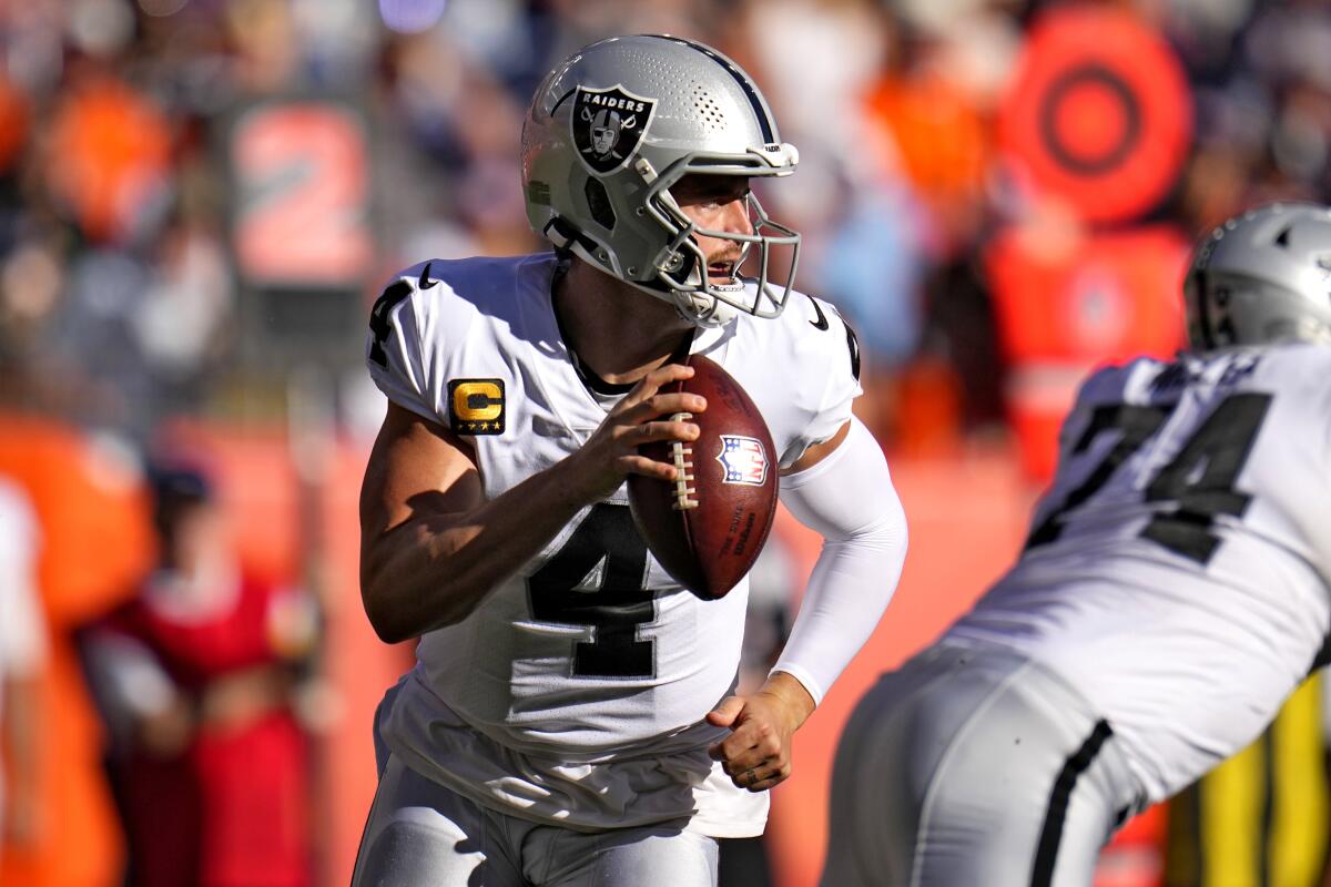 Las Vegas Raiders quarterback Derek Carr looks to pass against the Denver Broncos on Sunday.