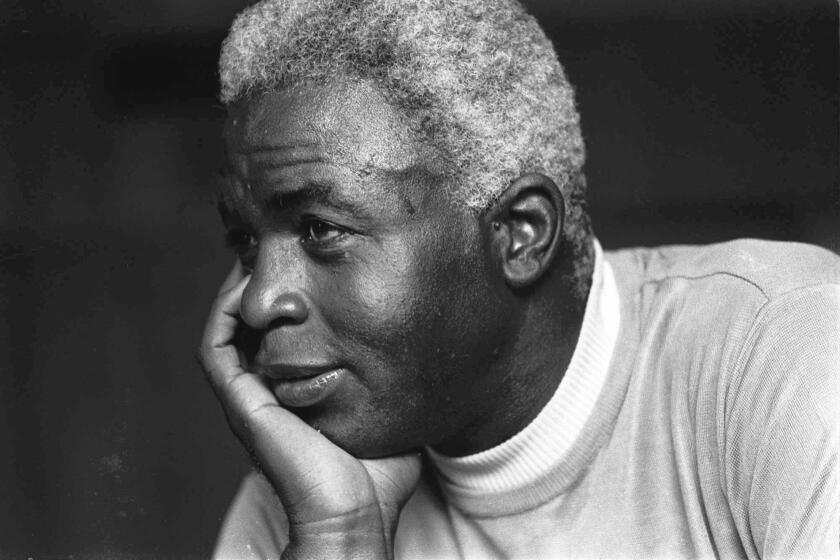 @@*@@* FILE @@*@@* Jackie Robinson looks pensive at his Stamford, Conn., home, in this June 30, 1971 file photo, as he discusses the death of his son Jack, Jr.(AP Photo)
