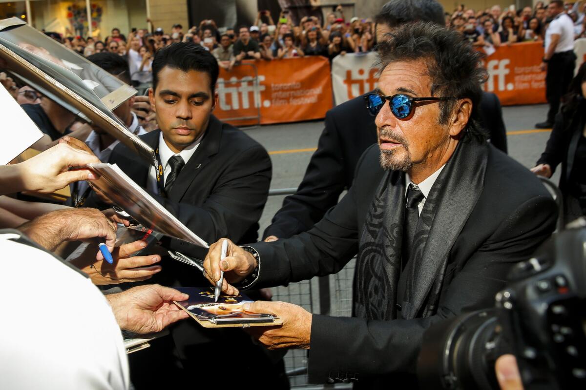 Al Pacino signs an autograph at the Toronto International Film Festival, where he's debuting his new film, "The Humbling."