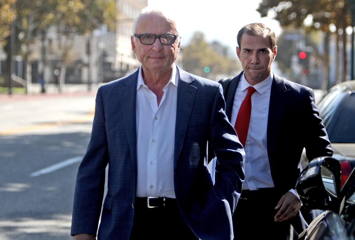 Honolulu Manor Senior Apartments owner Elias Shokrian, left, and his attorney Thomas Sands leave the Glendale Courthouse after a September court hearing about the property's elevator problems. This week, the suit was dismissed after a city inspector found both elevators working. For about 15 months, at least one of the property's two elevators was not working or up to code.