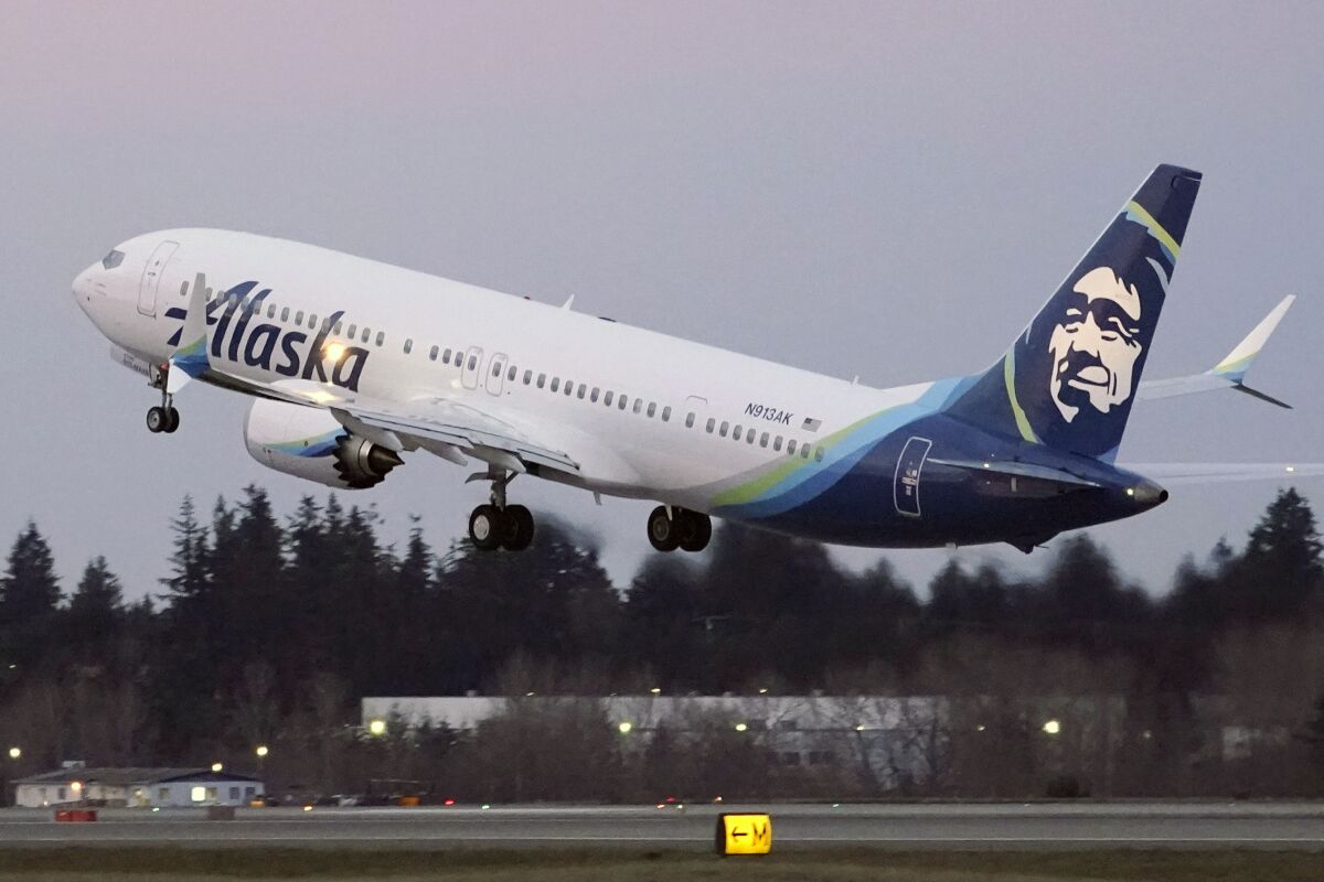 FILE - In this Monday, March 1, 2021 file photo, The first Alaska Airlines passenger flight on a Boeing 737-9 Max airplane takes off on a flight to San Diego from Seattle-Tacoma International Airport in Seattle. A Boeing pilot involved in testing the 737 Max jetliner was indicted Thursday, Oct. 14,2021 by a federal grand jury on charges of deceiving safety regulators who were evaluating the plane, which was later involved in two deadly crashes. (AP Photo/Ted S. Warren, File)