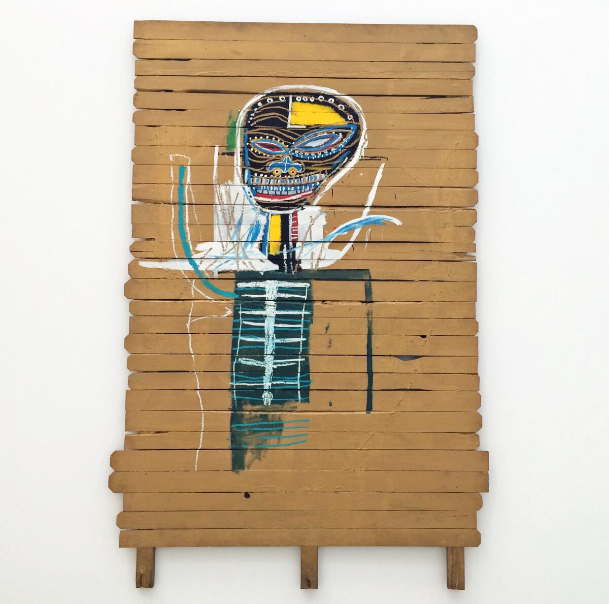 A painting by Jean-Michel Basquiat shows a black, skeletal figure on wooden planks painted a golden color