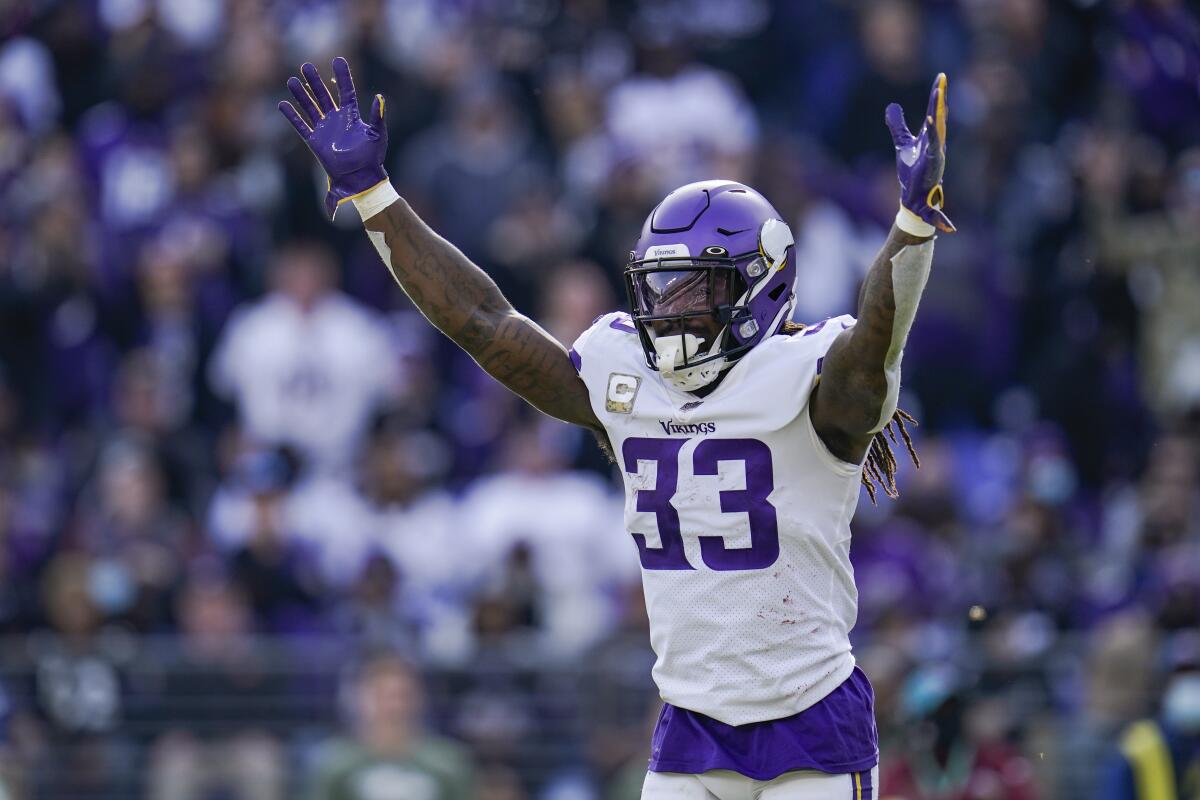 Minnesota Vikings running back Dalvin Cook raises his arms in celebration after a touchdown by quarterback Kirk Cousins.