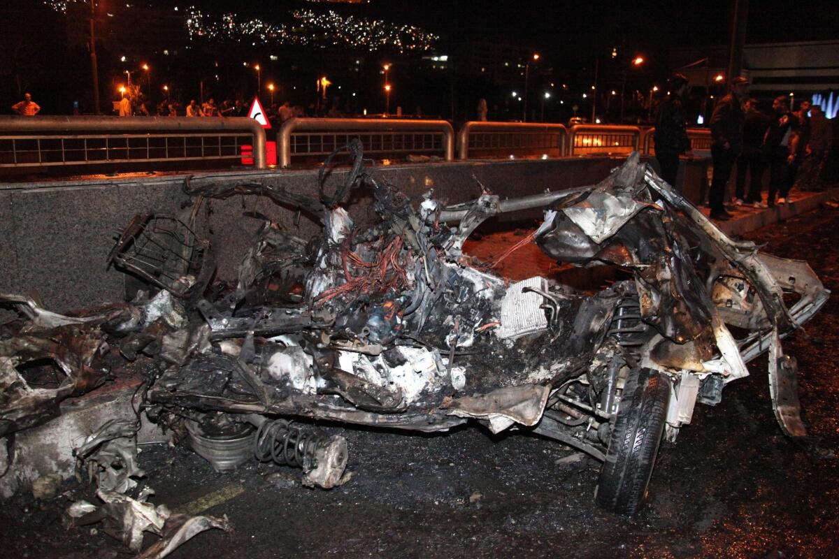 A picture released by the official Syrian Arab News Agency on Sunday shows the remains of a vehicle after two cars laden with explosives blew up in the center of the Syrian capital, Damascus, state media reported.
