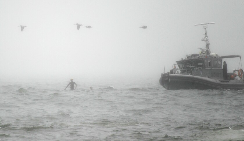 The L.A. County Sheriff’s Department searches for a missing swimmer off Venice Beach on Monday.