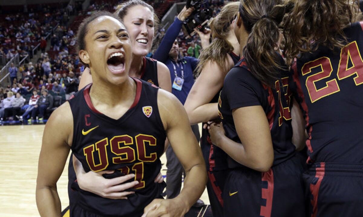 USC's Alexyz Vaioletama, left, celebrates with her teammates after the Trojans' 72-68 upset victory over Stanford in the Pac-12 tournament Saturday.