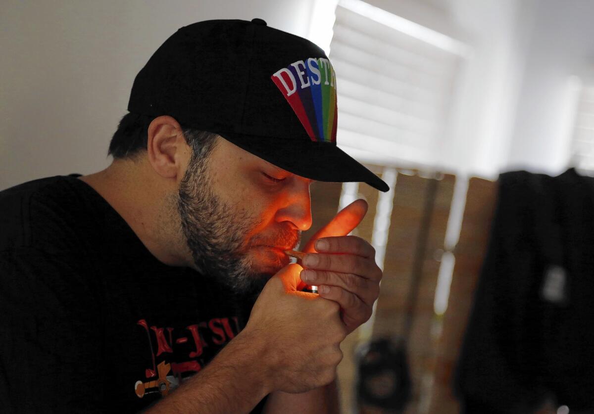 Brian Reichle lights a joint he just received from Speed Weed, which delivers medical marijuana to thousands of customers in Los Angeles and Orange counties.