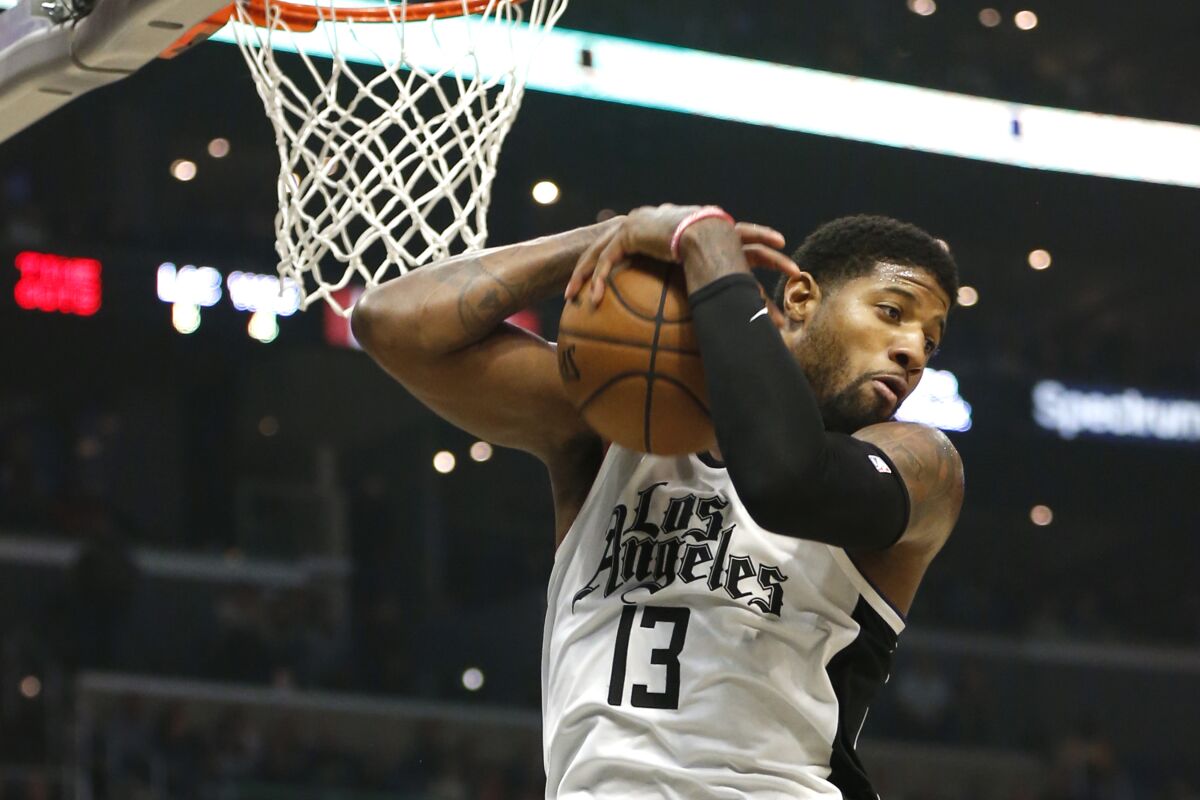 Clippers forward Paul George grabs a rebound.