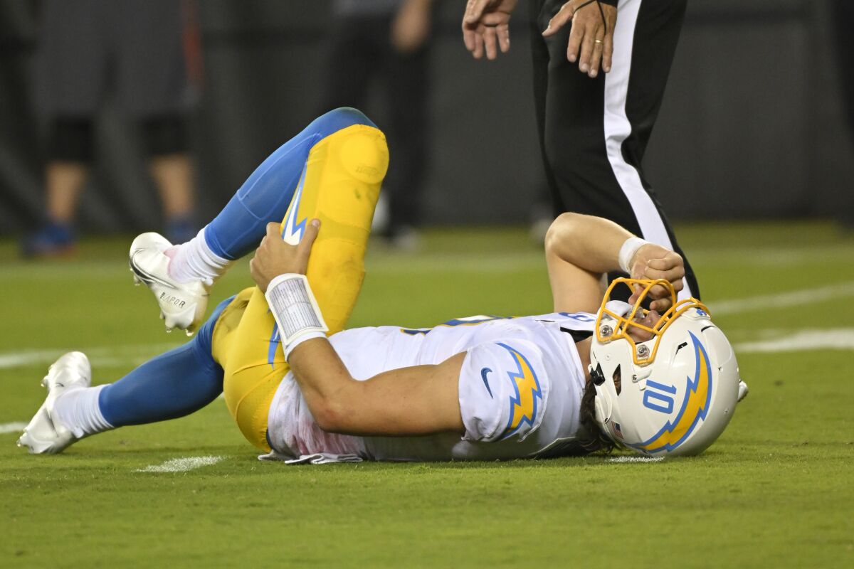 Chargers quarterback Justin Herbert is slow to get up after getting hit in the fourth quarter against the Chiefs on Thursday.