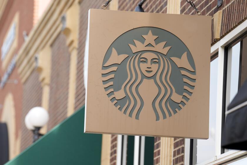 FILE - Starbucks sign hangs outside a casino along Main Street Wednesday, Sept. 20, 2023, in Deadwood, S.D. Starbucks will reports earnings on Tuesday, April 30, 2024. (AP Photo/David Zalubowski)