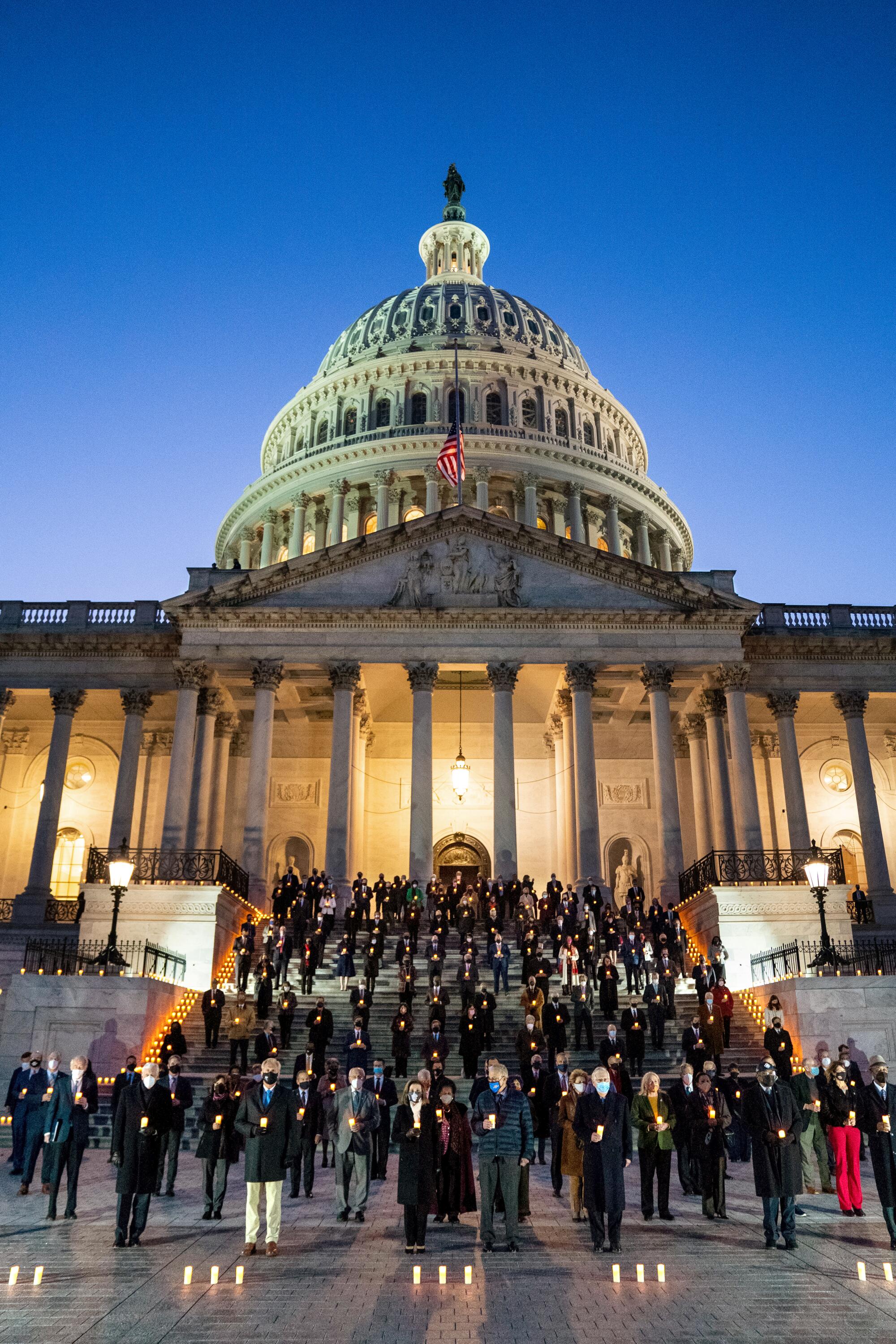 Feb. 13: Members of the 117th Congress hold candles outside the U.S. Capitol.