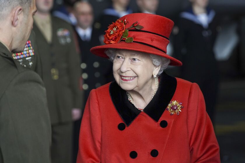 Britain's Queen Elizabeth II visits the HMS Queen Elizabeth at HM Naval Base, ahead of the ship's maiden deployment, in Portsmouth, England, Saturday May 22, 2021. HMS Queen Elizabeth will be leading a 28-week deployment to the Far East that Prime Minister Boris Johnson has insisted is not confrontational towards China. (Steve Parsons/Pool Photo via AP)