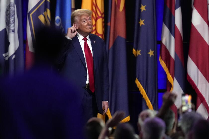 Republican presidential nominee former President Donald Trump puts his hand to his ear after speaking at the National Guard Association of the United States' 146th General Conference, Monday, Aug. 26, 2024, in Detroit. (AP Photo/Paul Sancya)