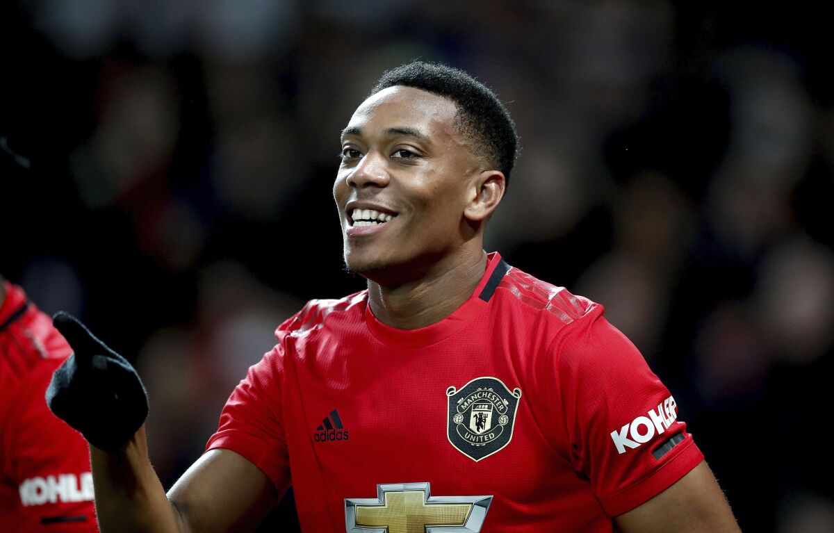 Manchester United's Anthony Martial celebrates scoring during the English Premier League soccer match between Manchester United and Norwich City at Old Trafford, Manchester, England, Saturday Jan. 11, 2020. (Martin Rickett/PA via AP)
