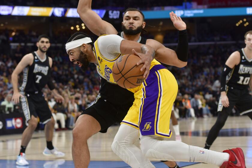 Los Angeles Lakers forward Anthony Davis drives against Memphis Grizzlies forward David Roddy during the second half of Game 2 in a first-round NBA basketball playoff series Wednesday, April 19, 2023, in Memphis, Tenn. (AP Photo/Brandon Dill)