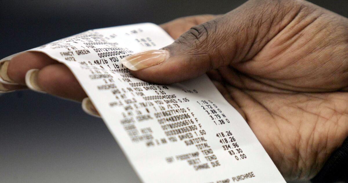 A customer checks her sales receipt at a Wal-Mart in Vancouver, Wash. 