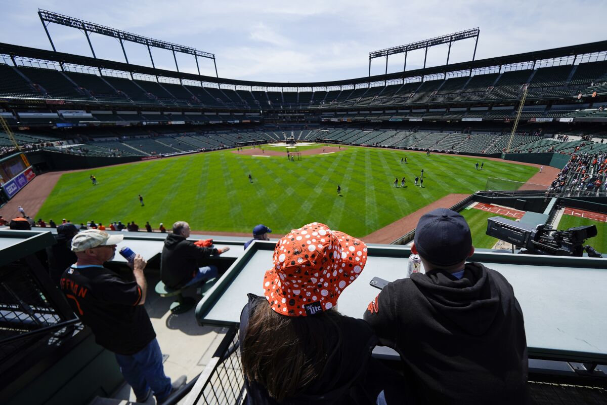 Fans watch batting practice before a game between the Baltimore Orioles and the Milwaukee Brewers.