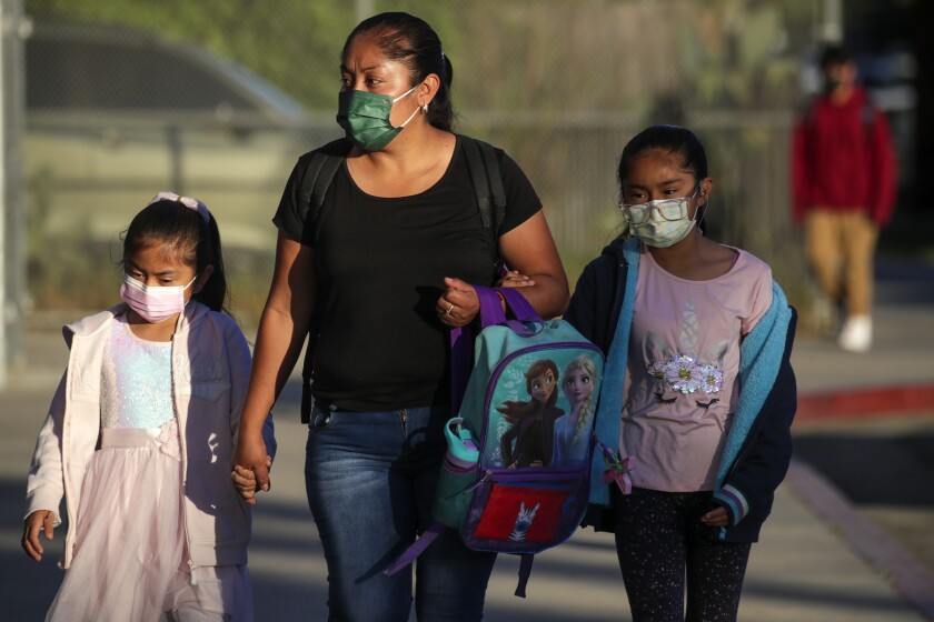 Los Angeles, CA - March 23: LAUSD students and staff are permitted to remove their masks. Students arriving in face masks Dr. Julian Nava Learning Academy on Wednesday, March 23, 2022 in Los Angeles, CA. (Irfan Khan / Los Angeles Times)