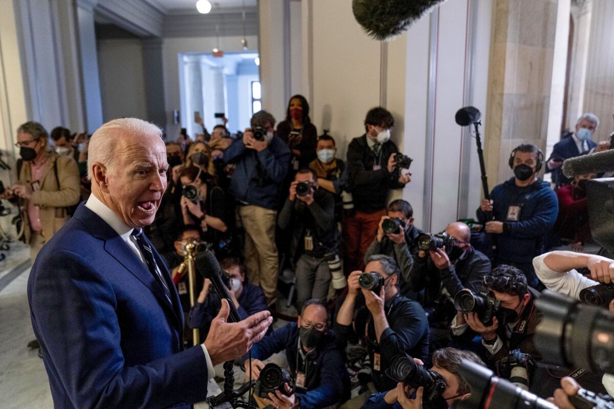 President Joe Biden speaks to members of the media as he leaves a meeting with the Senate Democratic Caucus to discuss voting rights and election integrity on Capitol Hill in Washington, Thursday, Jan. 13, 2022. (AP Photo/Andrew Harnik)