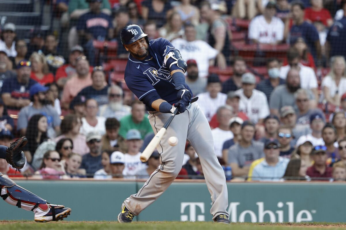 FILE - Tampa Bay Rays' Nelson Cruz connects on an RBI-double against the Boston Red Sox during the 10th inning of a baseball game Monday, Sept. 6, 2021, at Fenway Park in Boston. A person with direct knowledge of the deal tells The Associated Press that the free agent slugger and the Washington Nationals have agreed to a one-year contract. (AP Photo/Winslow Townson, File)