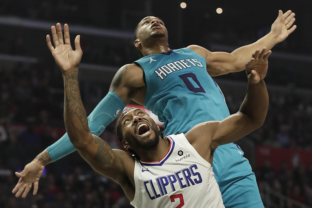 Charlotte Hornets forward Miles Bridges blocks the dunk attempt of Clippers forward Kawhi Leonard. 