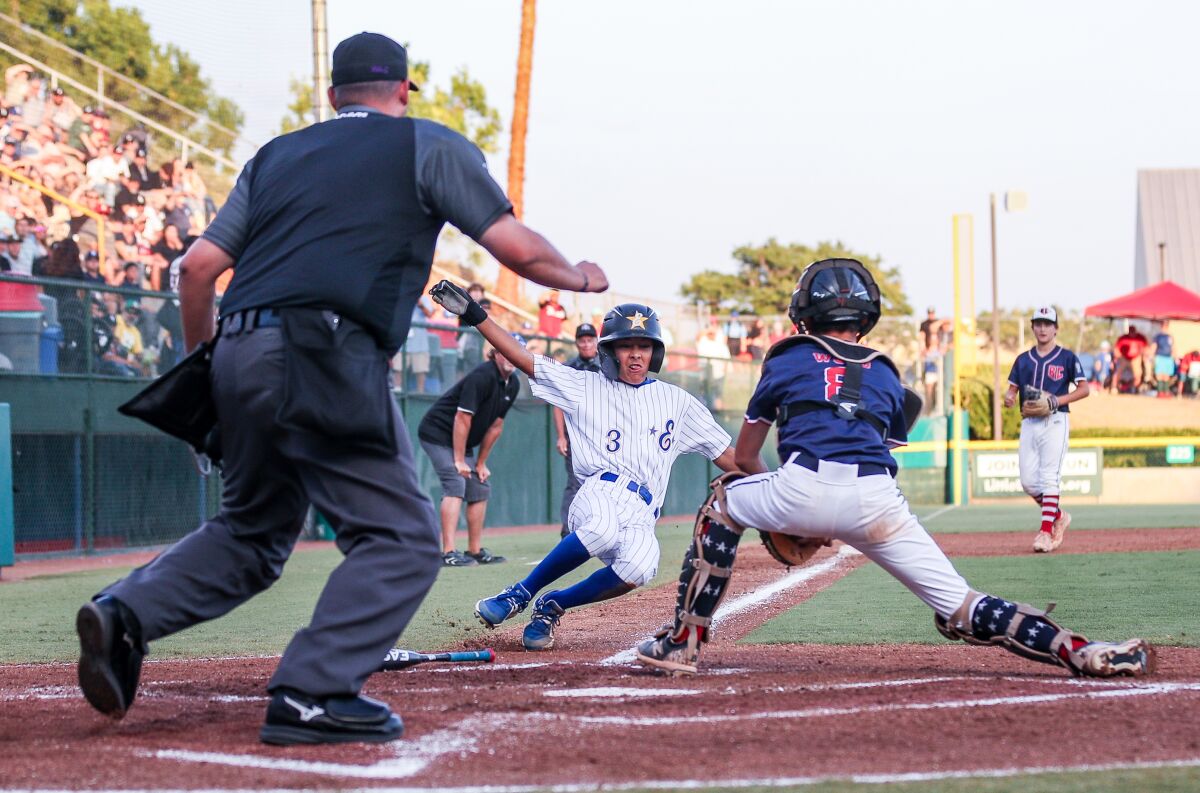 El Segundo's Lennon Salazar is out sliding at the plate in the West Regional final 